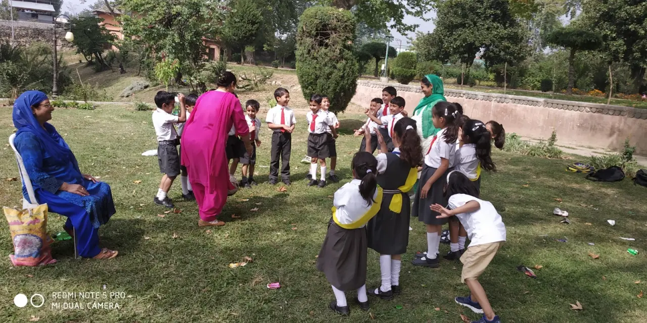 Students holding poster outdoors