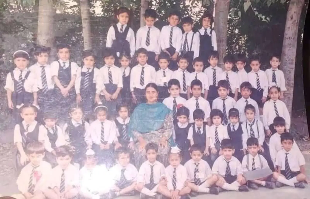 Students playing on grass with teachers